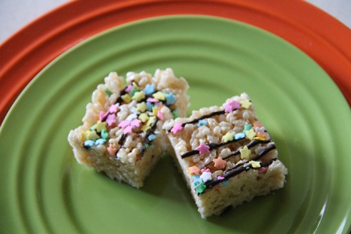 Two marshmallow crispy treats. Use chocolate drizzle and sprinkles to make them extra special!